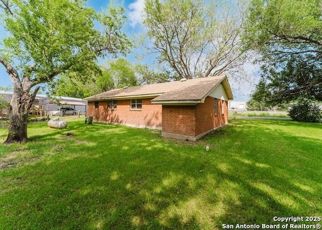 36 County Road 346c, Shiner, TX 77984 - back of house with a yard and brick siding