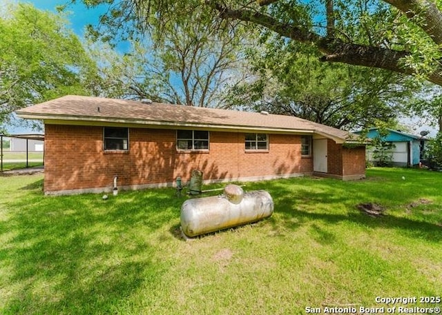 36 County Road 346c, Shiner, TX 77984 - rear view of house featuring a yard and brick siding