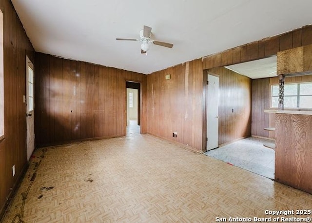 36 County Road 346c, Shiner, TX 77984 - empty room with wooden walls and a ceiling fan