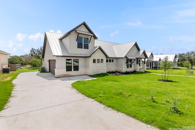 31 Peace Pipe, Wimberley, TX 78676 - modern farmhouse with driveway, board and batten siding, cooling unit, stone siding, and a front yard