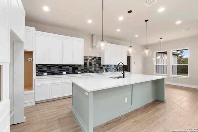 31 Peace Pipe, Wimberley, TX 78676 - kitchen featuring a sink, tasteful backsplash, white cabinetry, and recessed lighting