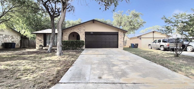 6115 Calderwood St, San Antonio, TX 78249 - ranch-style home with brick siding, an attached garage, and concrete driveway