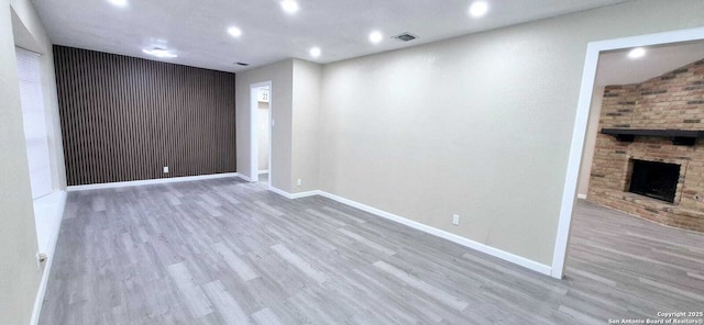 6115 Calderwood St, San Antonio, TX 78249 - empty room with wood finished floors, recessed lighting, baseboards, and a large fireplace