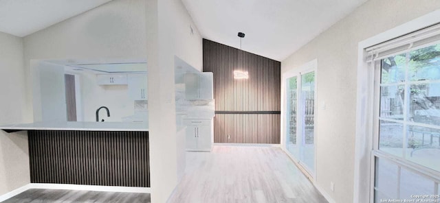 6115 Calderwood St, San Antonio, TX 78249 - kitchen featuring light wood finished floors, pendant lighting, light countertops, and baseboards