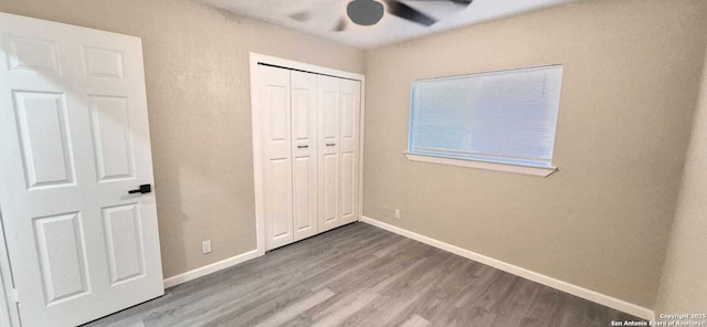 6115 Calderwood St, San Antonio, TX 78249 - unfurnished bedroom featuring wood finished floors, baseboards, a closet, and a ceiling fan