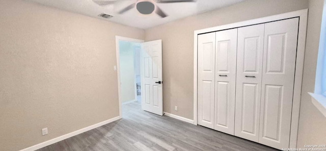 6115 Calderwood St, San Antonio, TX 78249 - unfurnished bedroom featuring wood finished floors, baseboards, ceiling fan, and a closet