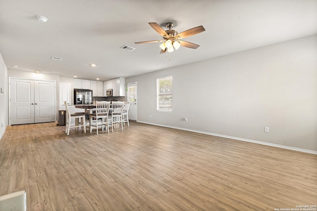 7207 Lincoln Trce, San Antonio, TX 78222 - kitchen with appliances with stainless steel finishes, white cabinetry, a ceiling fan, light wood finished floors, and recessed lighting