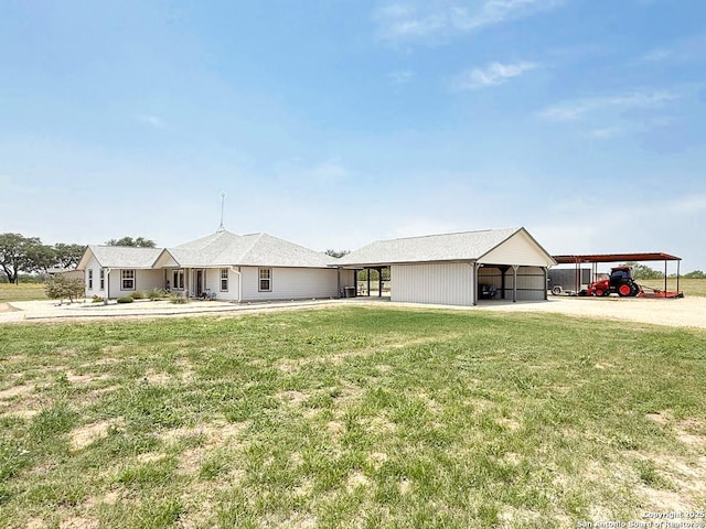 1185 County Road 7718, Devine, TX 78016 - view of front facade featuring a front yard, driveway, and a carport