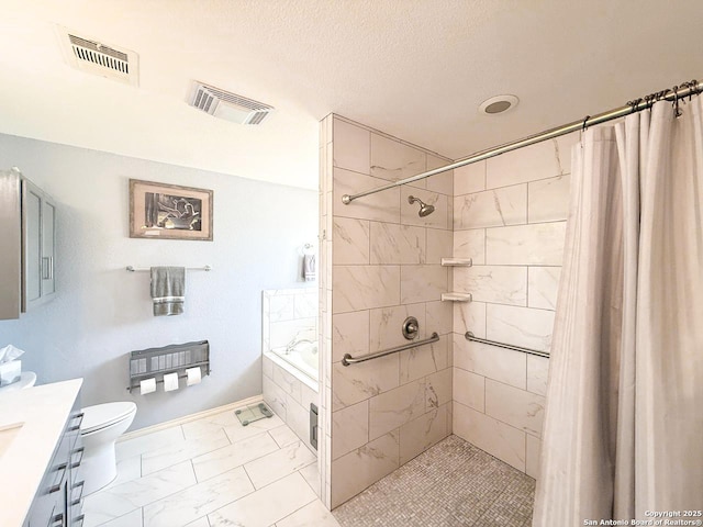 1185 County Road 7718, Devine, TX 78016 - full bath featuring vanity, marble finish flooring, tiled bath, a tile shower, and toilet