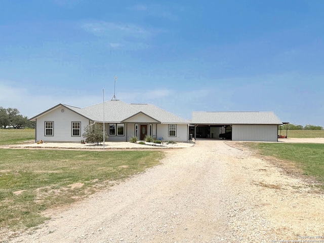 1185 County Road 7718, Devine, TX 78016 - ranch-style house featuring driveway, an attached carport, and a front yard