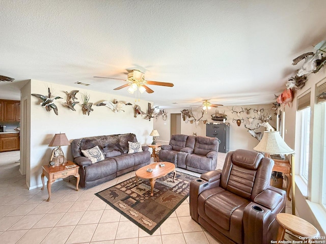 1185 County Road 7718, Devine, TX 78016 - living area with ceiling fan, light tile patterned flooring, and a textured ceiling
