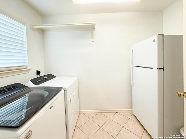 1185 County Road 7718, Devine, TX 78016 - laundry area with light tile patterned flooring, baseboards, and independent washer and dryer