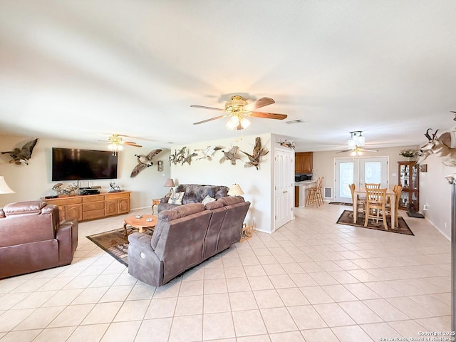 1185 County Road 7718, Devine, TX 78016 - living room featuring ceiling fan, light tile patterned floors, and baseboards