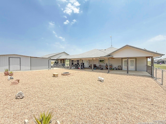 1185 County Road 7718, Devine, TX 78016 - back of house featuring a patio and a fire pit