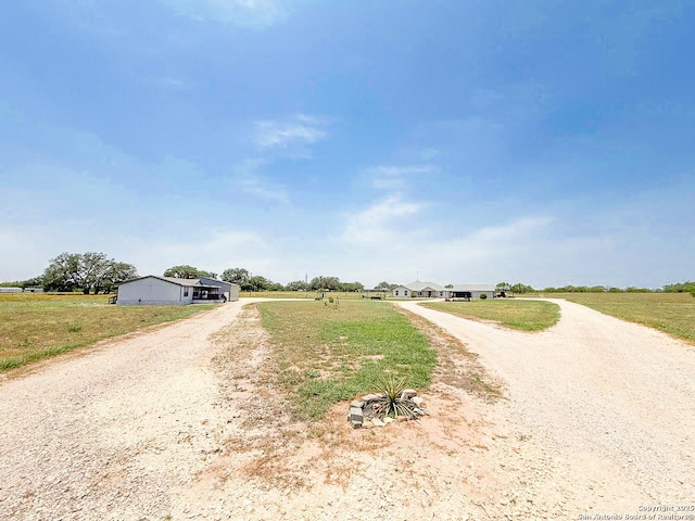 1185 County Road 7718, Devine, TX 78016 - view of dirt / gravel driveway with a view of countryside
