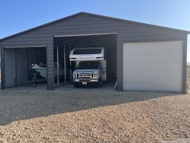 1185 County Road 7718, Devine, TX 78016 - view of parking / parking lot featuring a detached garage
