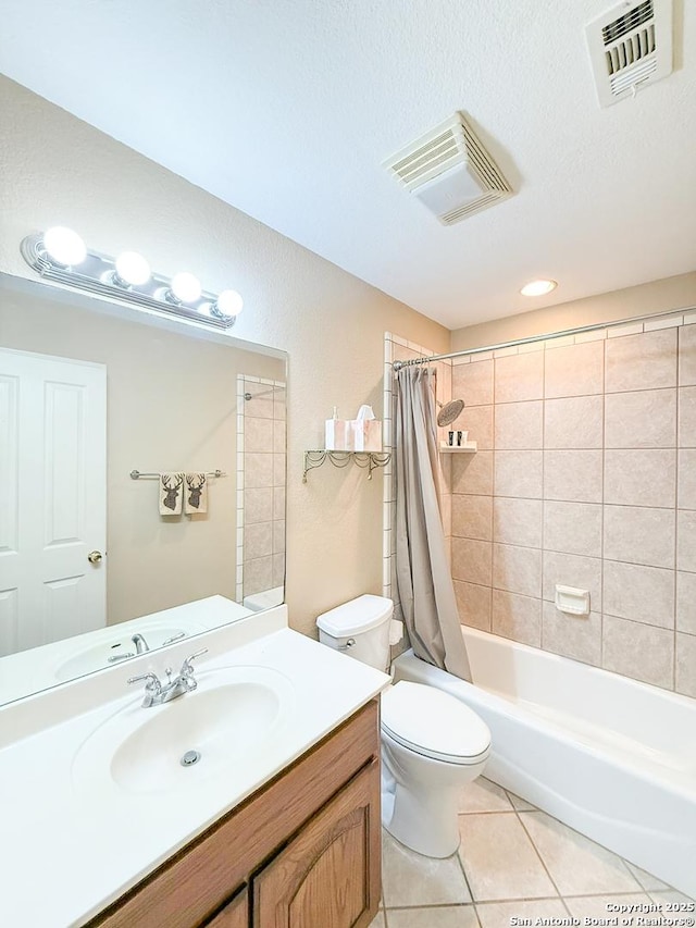 1185 County Road 7718, Devine, TX 78016 - bathroom with tile patterned flooring, vanity, toilet, and shower / bath combo with shower curtain