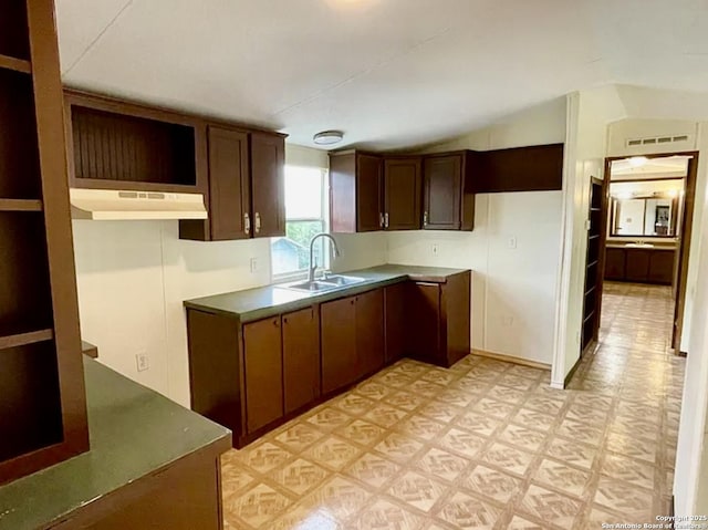 2230 Bear Springs Dr, San Antonio, TX 78245 - kitchen with under cabinet range hood, a sink, light flooring, and vaulted ceiling