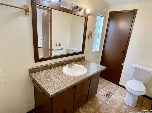 2230 Bear Springs Dr, San Antonio, TX 78245 - bathroom with toilet, vanity, and baseboards