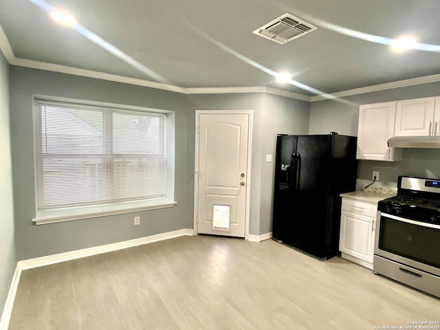 710 Garden Mdw, Universal City, TX 78148 - kitchen with gas stove, black fridge with ice dispenser, under cabinet range hood, light wood-style floors, and white cabinetry