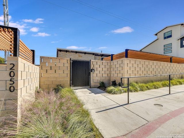 2050 Lohmans Spur Unit, Lakeway, TX 78734 - doorway to property with a gate