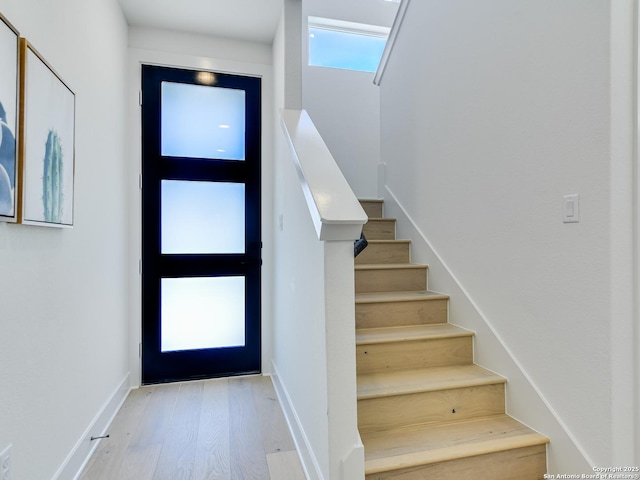 2050 Lohmans Spur Unit, Lakeway, TX 78734 - entrance foyer with wood finished floors, stairway, and baseboards