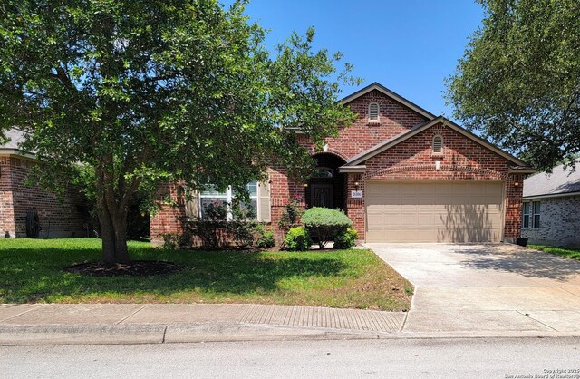 26106 Indian Clf, San Antonio, TX 78260 - view of front of house featuring brick siding, a garage, driveway, and a front lawn