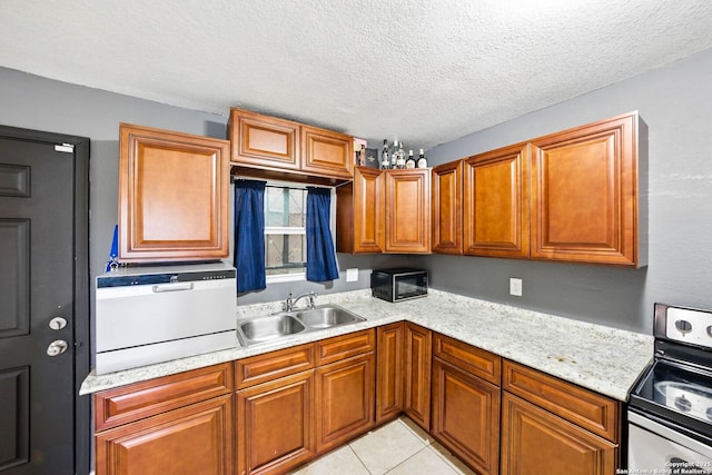 7122 Brecon, San Antonio, TX 78239 - kitchen featuring stainless steel electric range oven, a sink, brown cabinetry, a textured ceiling, and light tile patterned flooring