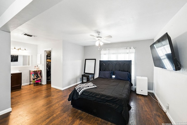 7122 Brecon, San Antonio, TX 78239 - bedroom featuring a spacious closet, wood finished floors, and baseboards