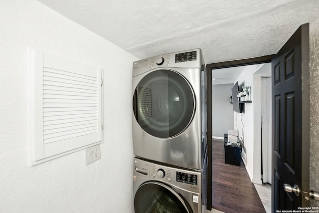 7122 Brecon, San Antonio, TX 78239 - washroom with estacked washer and dryer, wood finished floors, and a textured ceiling