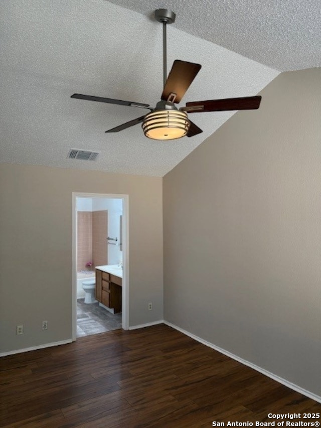 6210 Valley Clf, San Antonio, TX 78250 - spare room with ceiling fan, a textured ceiling, vaulted ceiling, dark wood-style flooring, and baseboards
