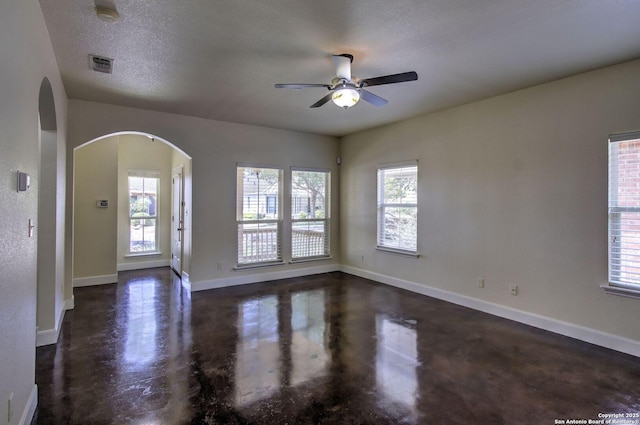 2222 Gruene Lk, New Braunfels, TX 78130 - unfurnished room featuring concrete floors, a ceiling fan, arched walkways, baseboards, and a smoke detector