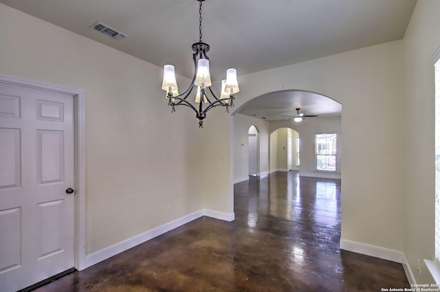 2222 Gruene Lk, New Braunfels, TX 78130 - unfurnished dining area featuring arched walkways, a chandelier, concrete flooring, and baseboards