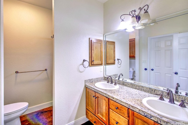 2222 Gruene Lk, New Braunfels, TX 78130 - full bath with toilet, double vanity, baseboards, and a textured wall