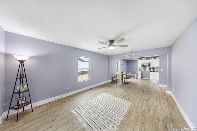 1437 Avant, San Antonio, TX 78210 - living area with light wood finished floors, baseboards, and ceiling fan
