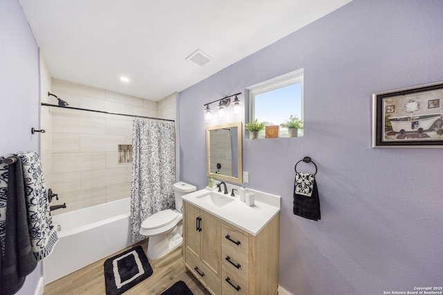 1437 Avant, San Antonio, TX 78210 - bathroom with toilet, vanity, wood finished floors, and shower / bathtub combination with curtain