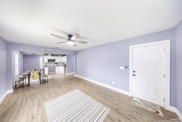 1437 Avant, San Antonio, TX 78210 - living area with light wood-type flooring, baseboards, and a ceiling fan