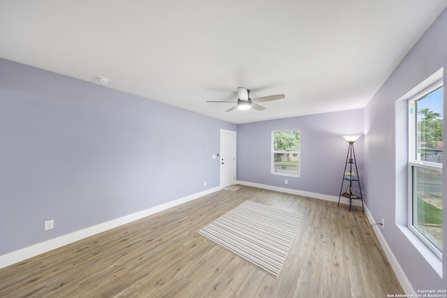 1437 Avant, San Antonio, TX 78210 - spare room with light wood finished floors, ceiling fan, and baseboards