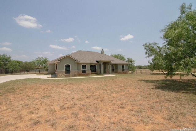 2516 County Road 357, La Vernia, TX 78121 - view of front of house with concrete driveway and a chimney