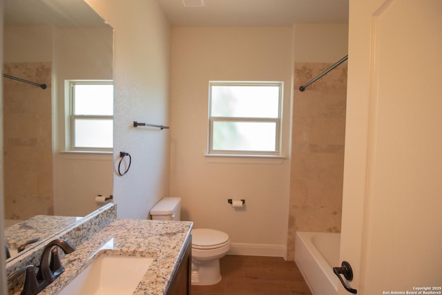 2516 County Road 357, La Vernia, TX 78121 - bathroom featuring vanity, toilet, washtub / shower combination, and baseboards