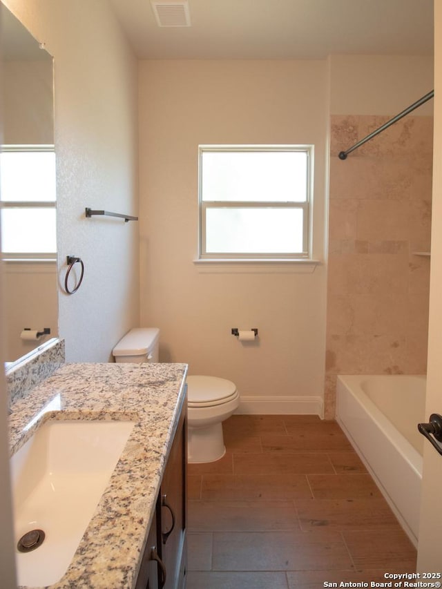 2516 County Road 357, La Vernia, TX 78121 - full bathroom with vanity, plenty of natural light, toilet, and wood finish floors