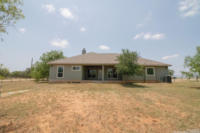 2516 County Road 357, La Vernia, TX 78121 - rear view of property featuring central AC unit and a chimney