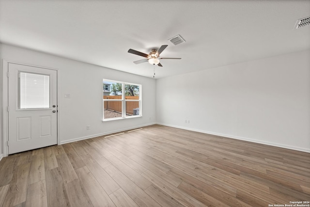 14923 Telfaire Mdw, Von Ormy, TX 78073 - spare room featuring a ceiling fan, light wood finished floors, and baseboards