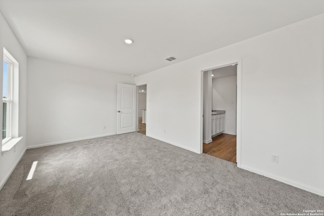14923 Telfaire Mdw, Von Ormy, TX 78073 - unfurnished bedroom with carpet flooring, baseboards, recessed lighting, and connected bathroom