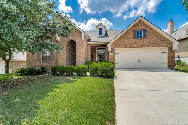 24919 Shuman Crk, San Antonio, TX 78255 - traditional-style home with brick siding, a front yard, driveway, a garage, and roof with shingles