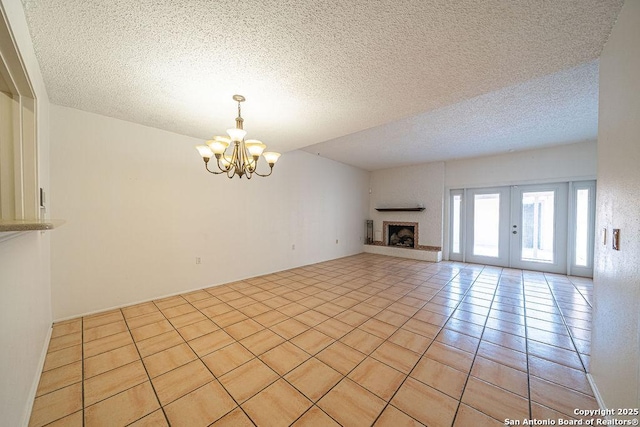3922 Barrington Unit 0, San Antonio, TX 78217 - unfurnished living room with a chandelier, a textured ceiling, light tile patterned floors, and a fireplace with raised hearth