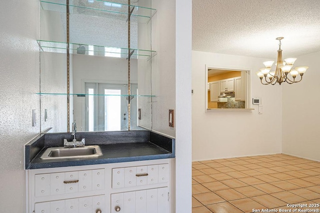 3922 Barrington Unit 0, San Antonio, TX 78217 - bathroom featuring a chandelier, vanity, a shower with shower door, and a textured ceiling