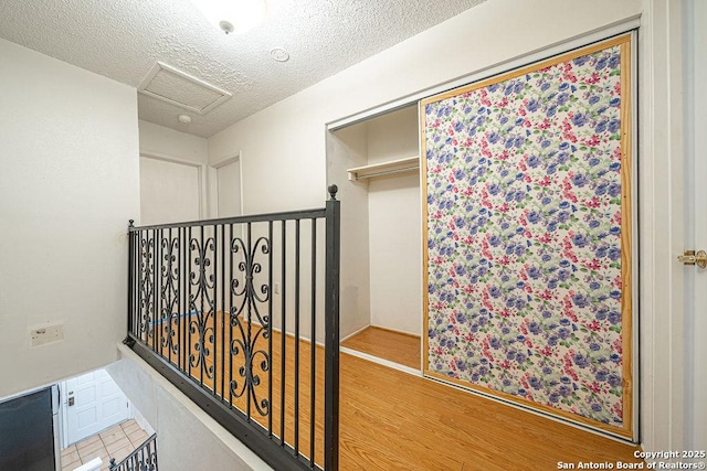 3922 Barrington Unit 0, San Antonio, TX 78217 - hallway with attic access, wood finished floors, and a textured ceiling