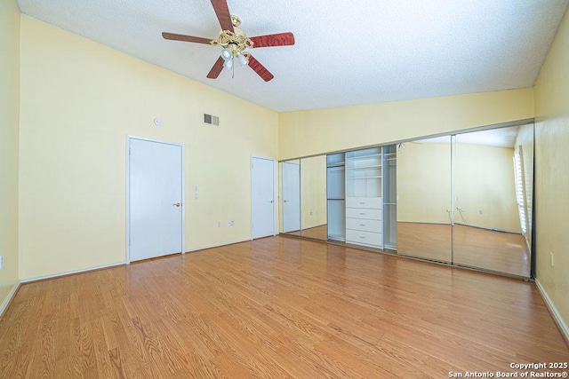 3922 Barrington Unit 0, San Antonio, TX 78217 - unfurnished bedroom with vaulted ceiling, light wood finished floors, ceiling fan, and a textured ceiling