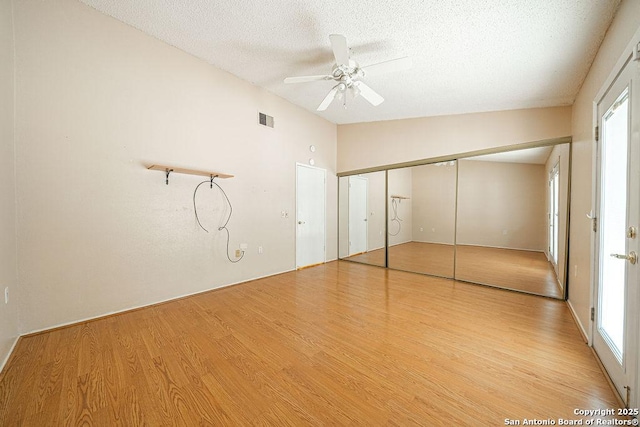 3922 Barrington Unit 0, San Antonio, TX 78217 - unfurnished bedroom featuring vaulted ceiling, wood finished floors, a textured ceiling, a closet, and ceiling fan